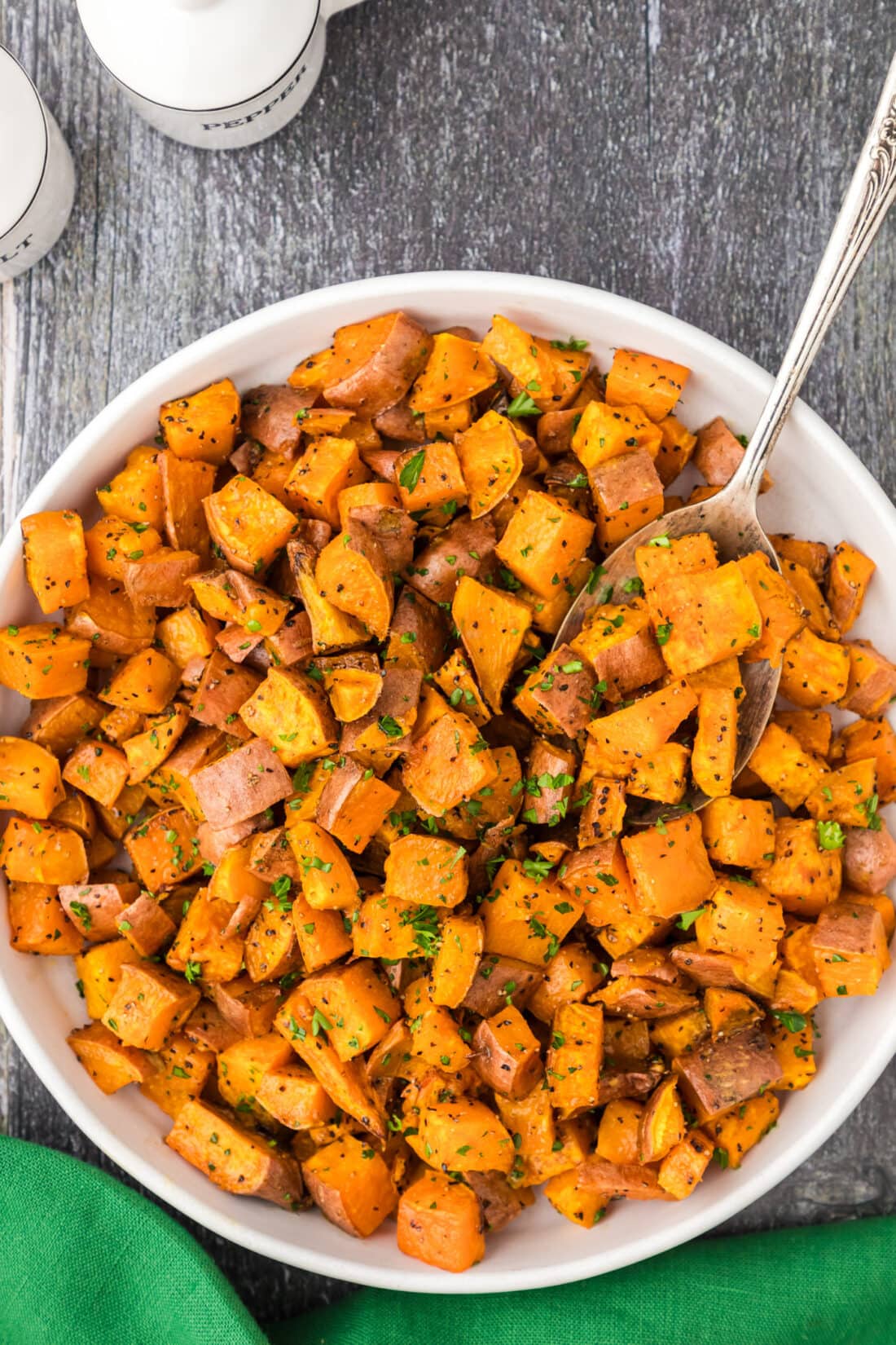 Bowl of Roasted Sweet Potatoes with a spoon in it