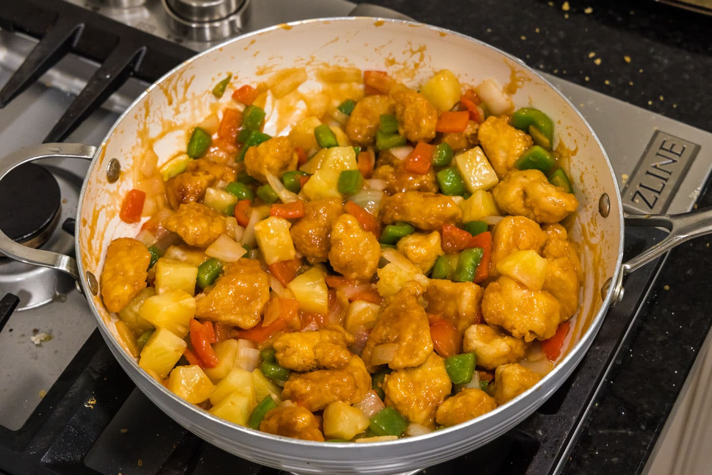 finished sweet and sour chicken with pineapple in a skillet