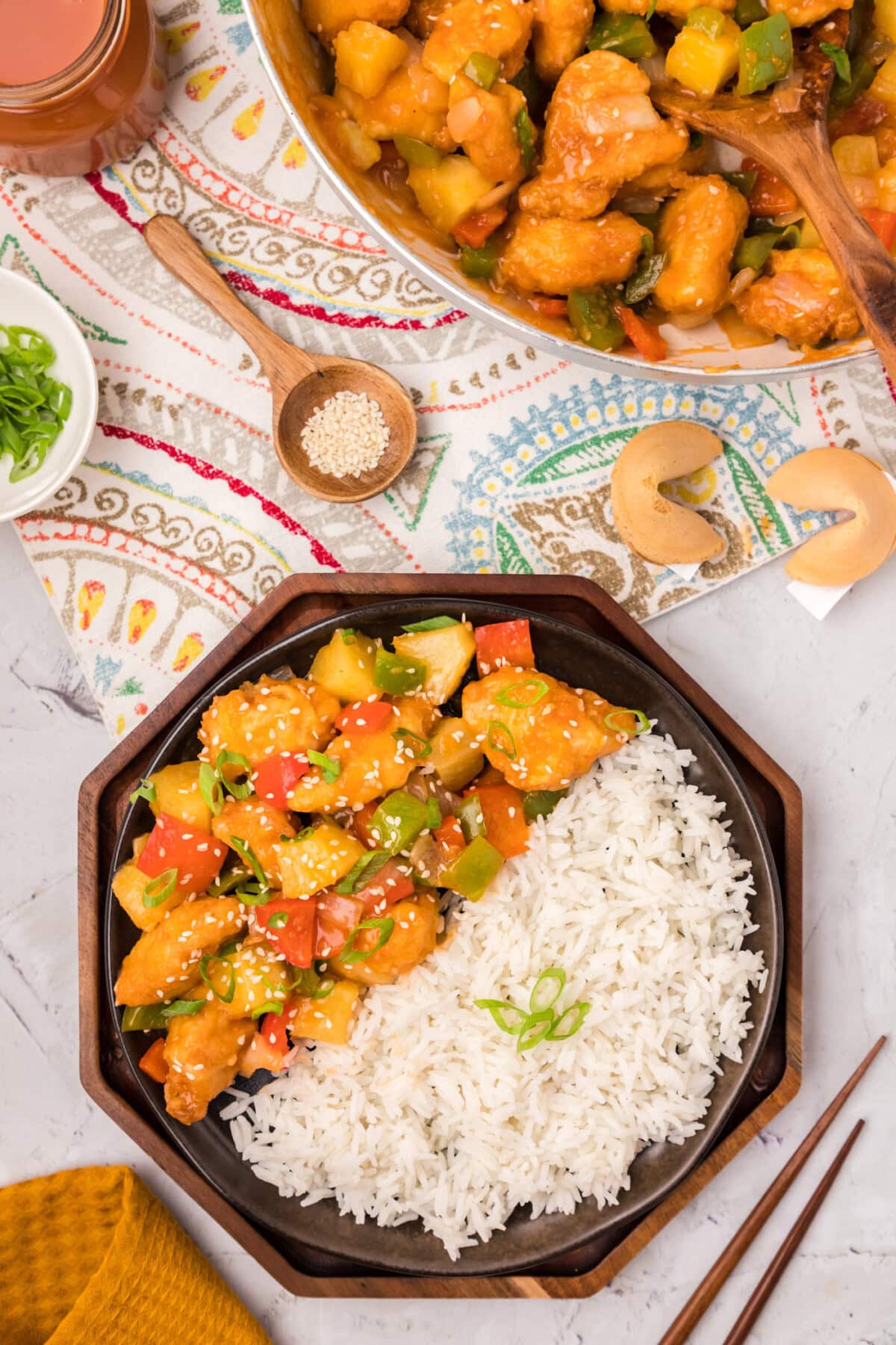 Plate of Sweet and Sour Chicken with rice on the side.