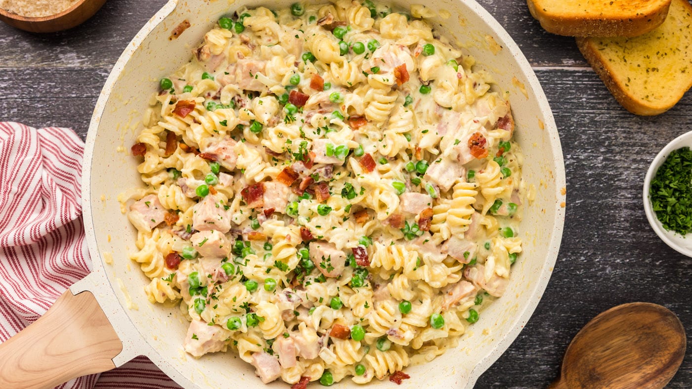 Turkey carbonara combines a creamy rich sauce with turkey, peas, and bacon making a super satisfying