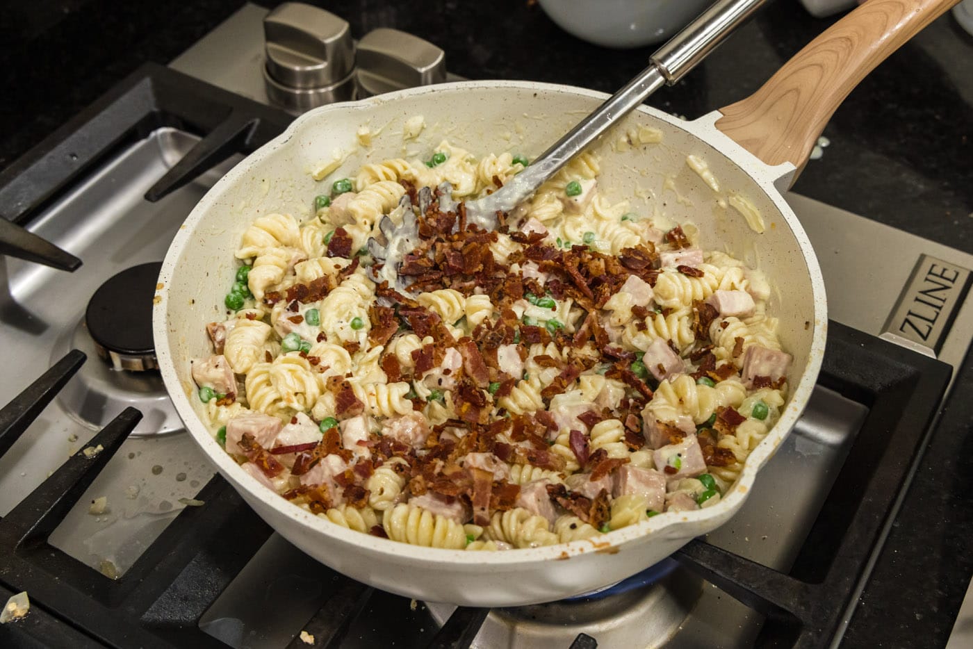diced cooked bacon added to skillet with turkey carbonara