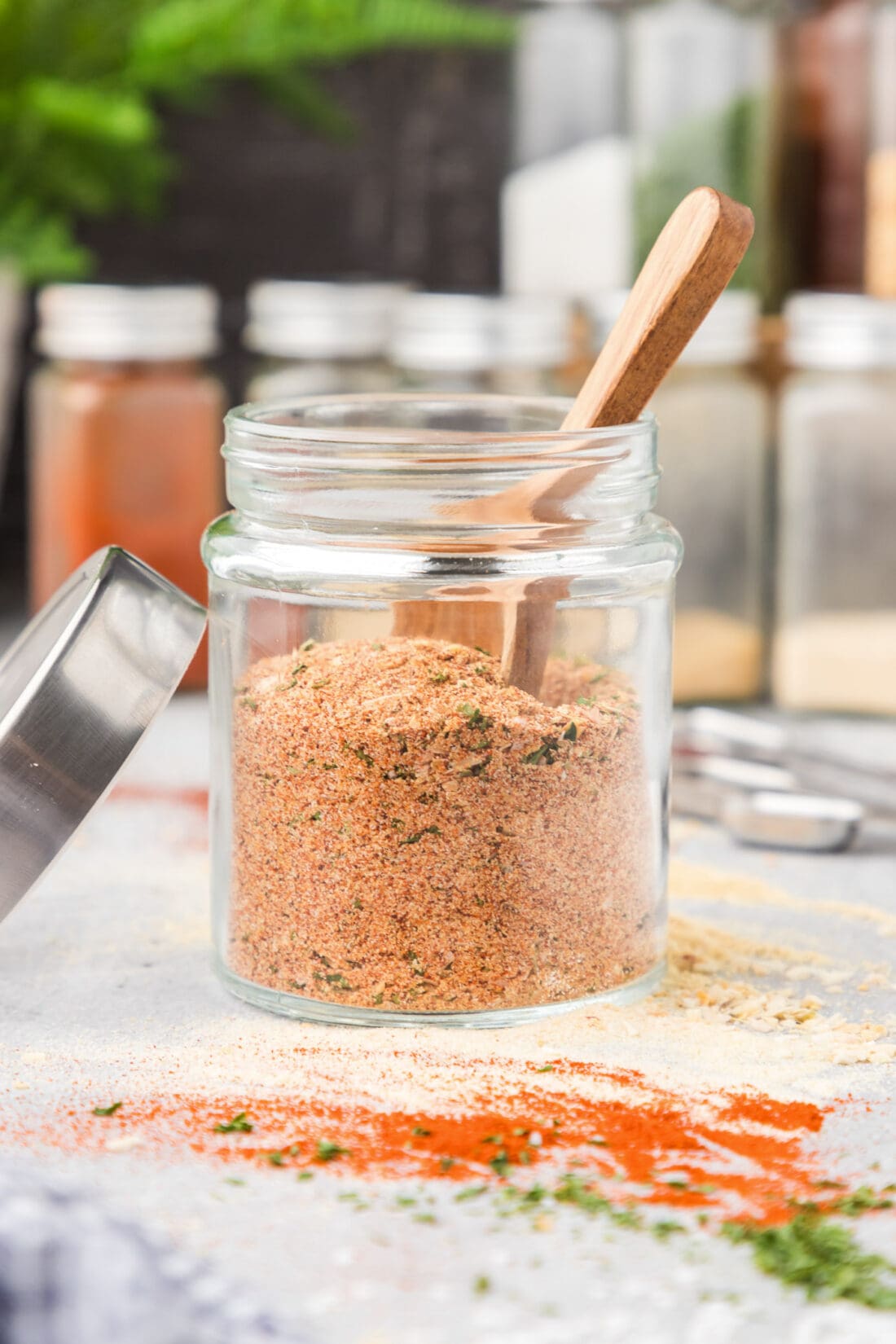 Jar of All Purpose Seasoning with a spoon in it