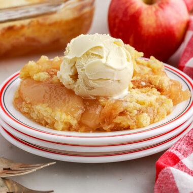 Apple Dump Cake on a plate topped with a scoop of ice cream