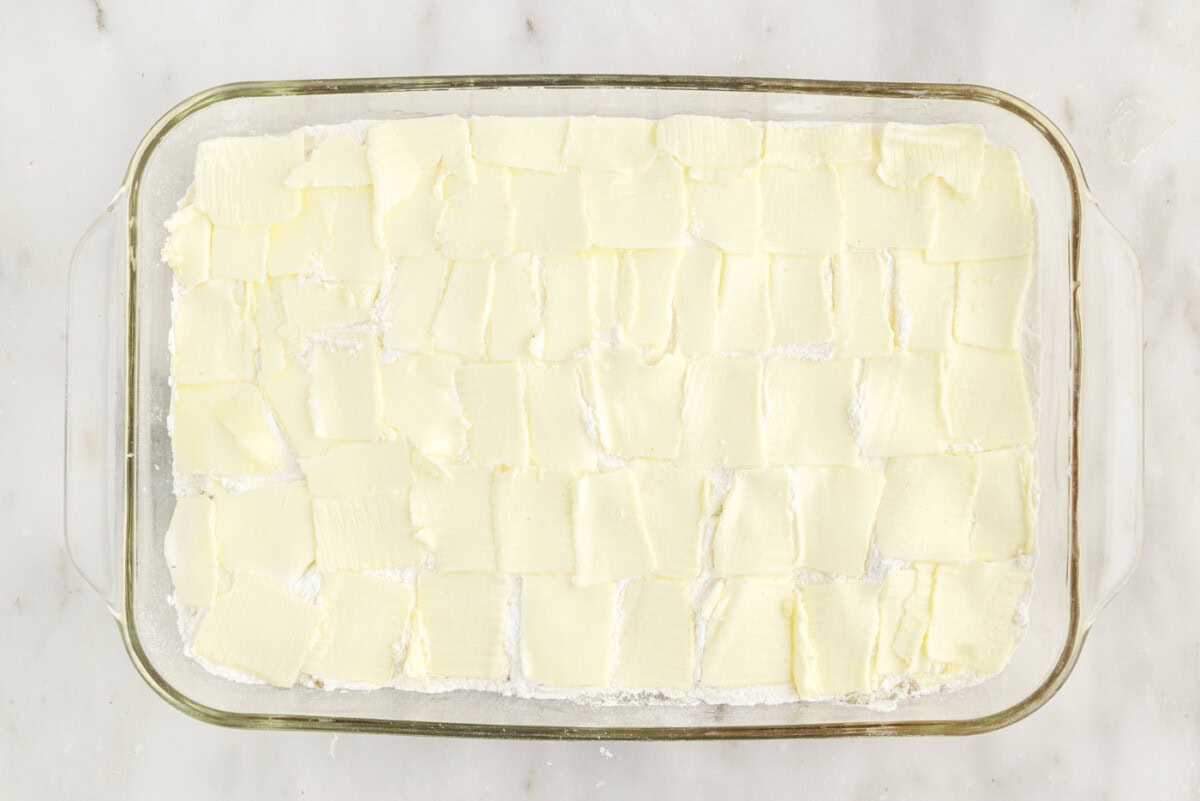 thin pats of butter over the top of cake mix and apple pie filling