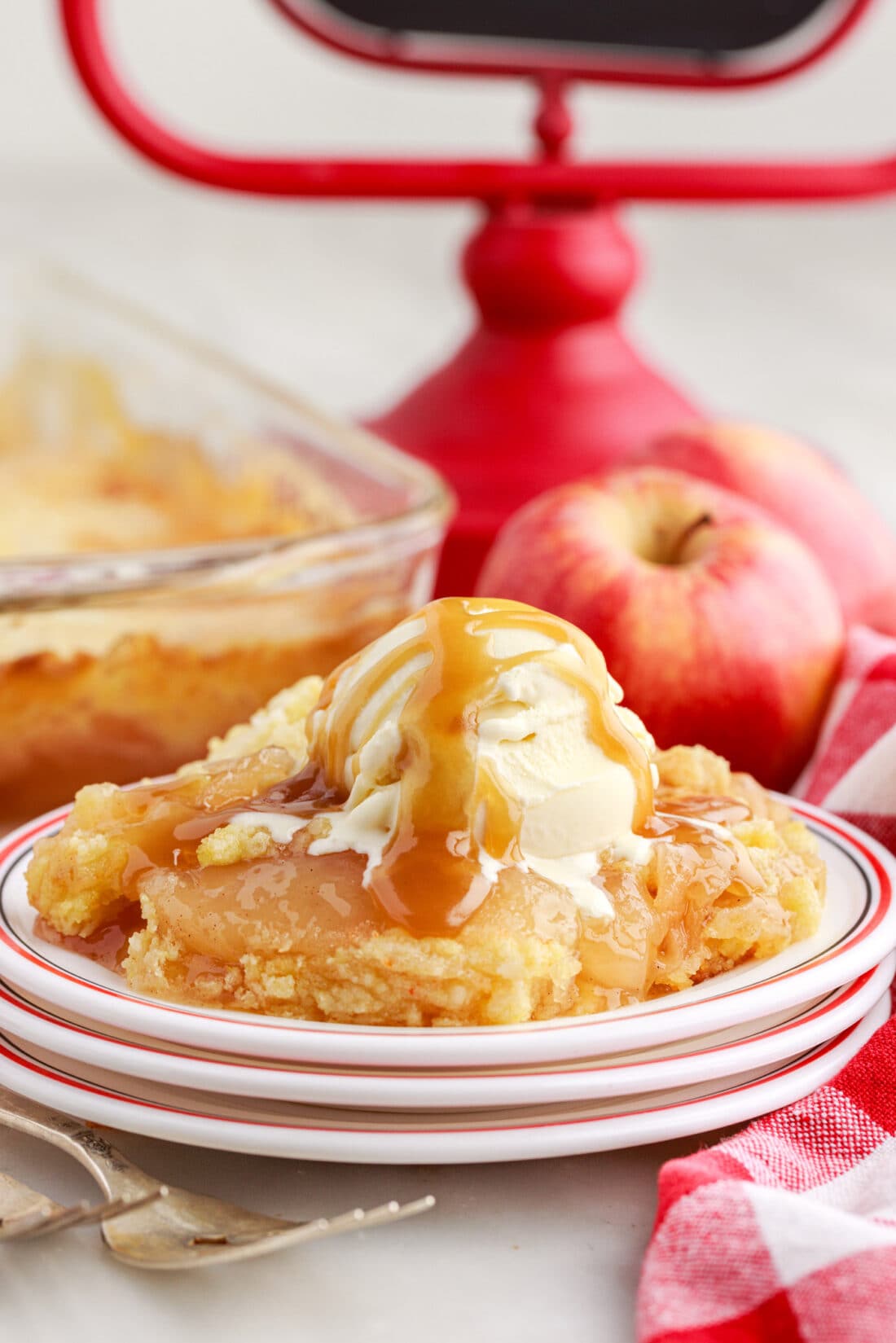 Apple Dump Cake on a plate toped with ice cream and caramel
