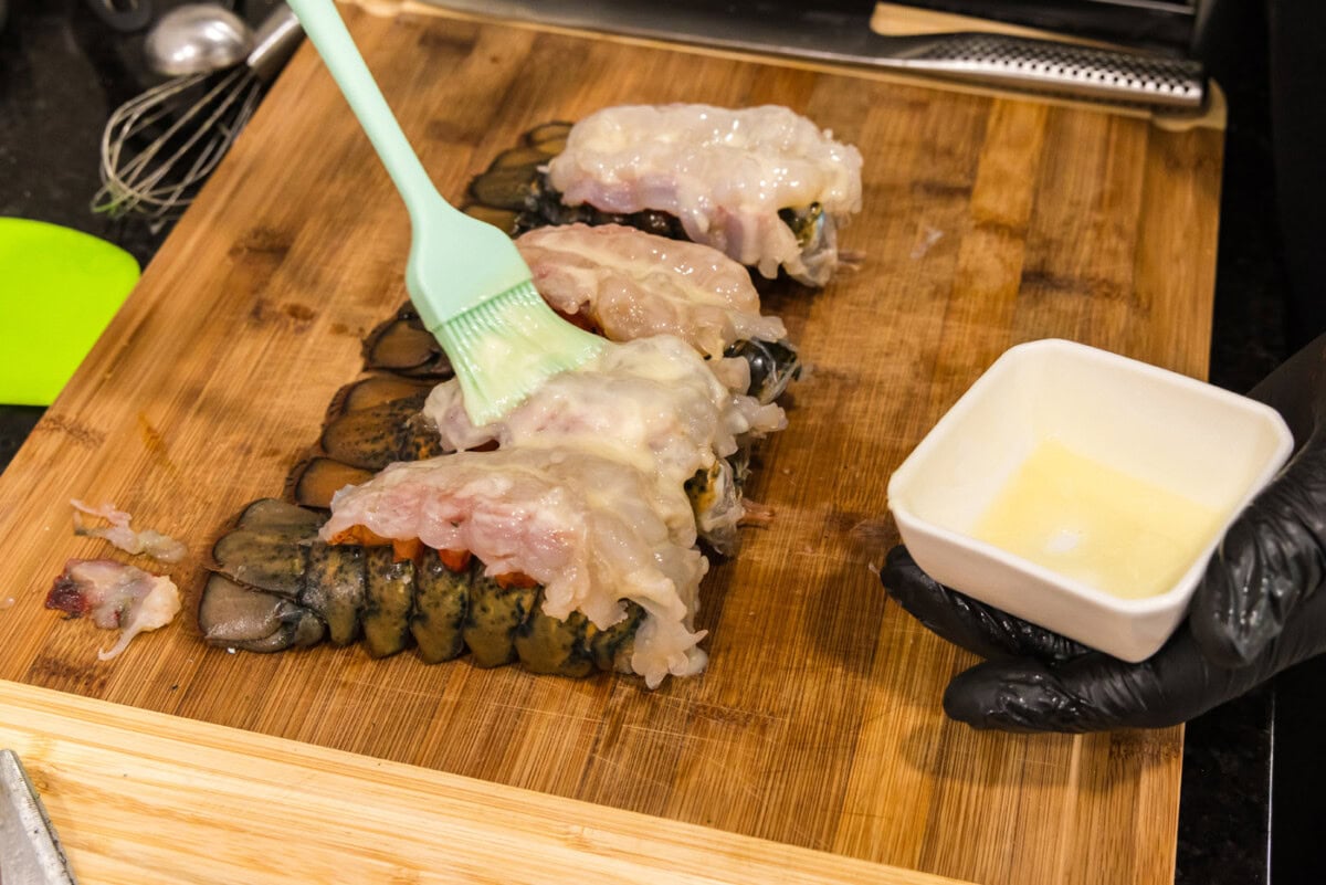 brushing crowned lobsters with melted butter