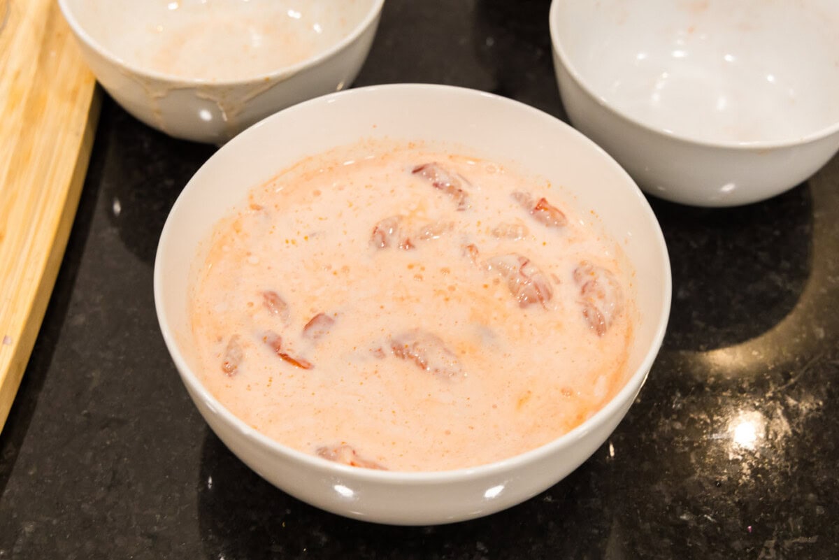 shrimp marinating in buttermilk and hot sauce