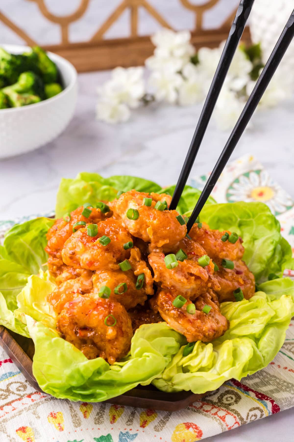 Chopsticks grabbing a piece of Bang Bang Shrimp