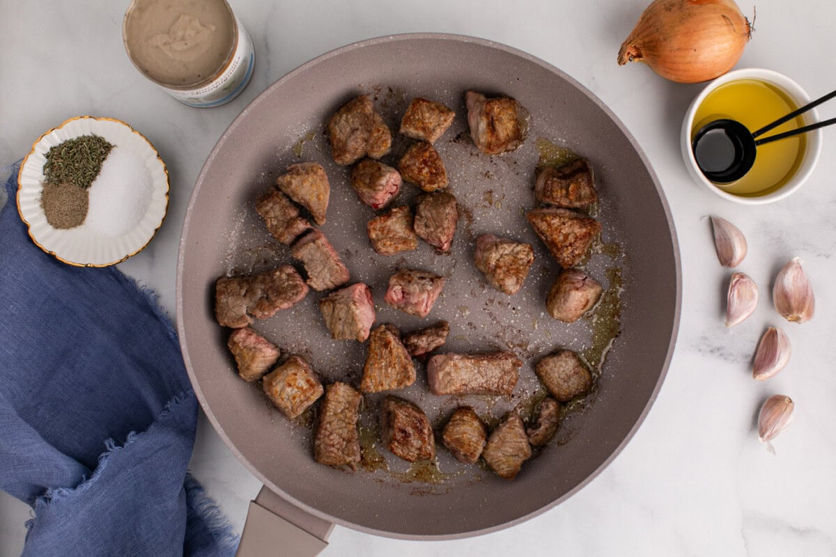 browned beef stew meat in a skillet
