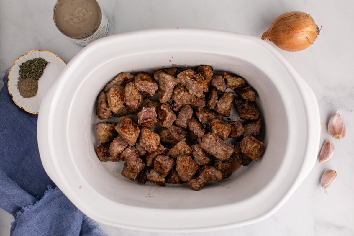 brown beef stew meat added to crockpot
