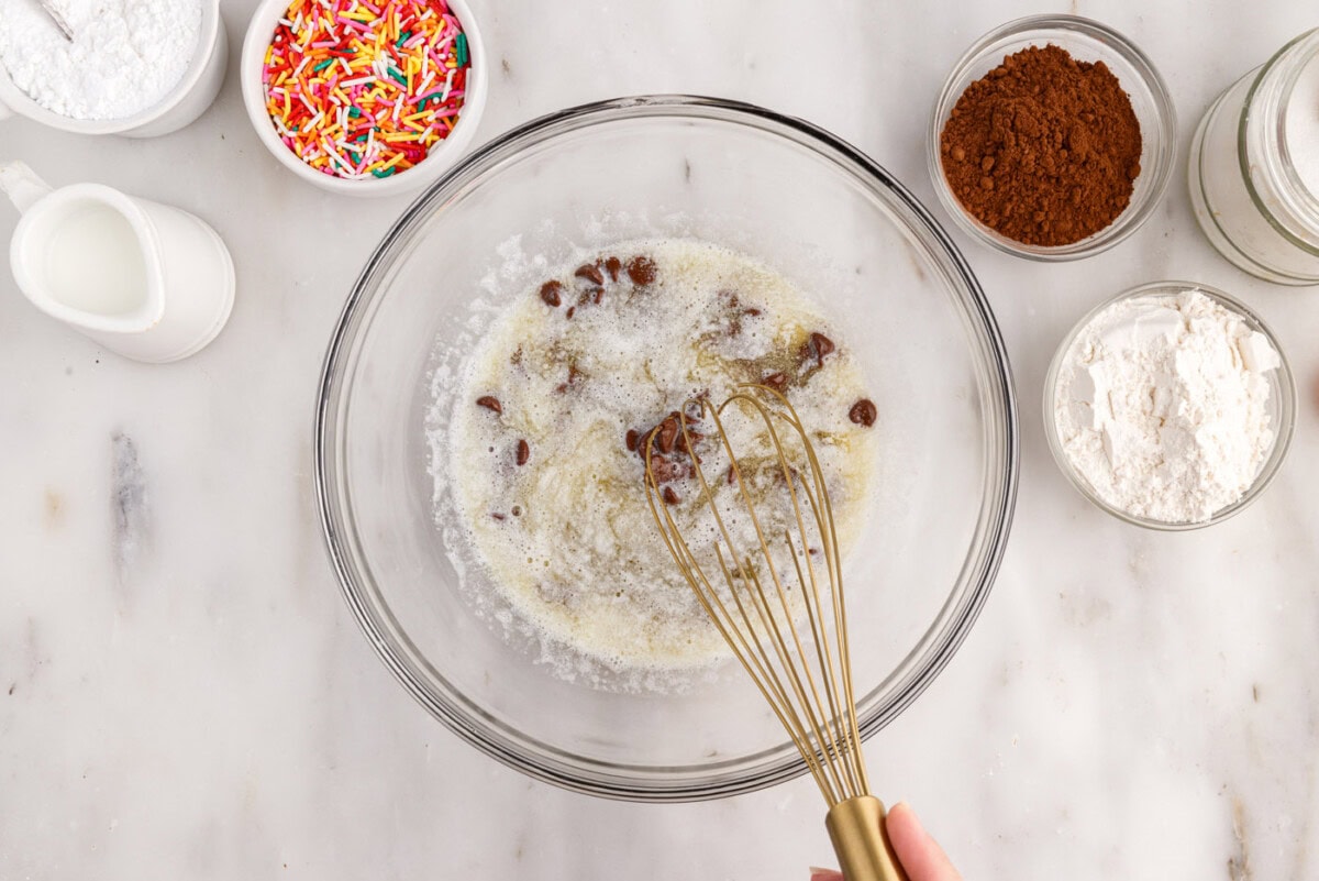 whisking butter and chocolate chips in a bowl