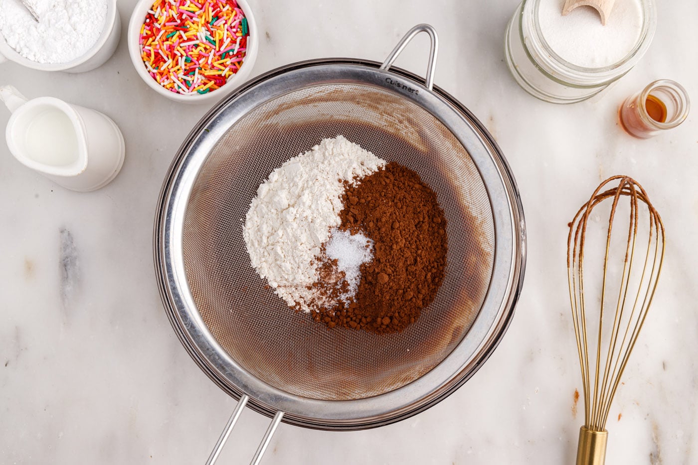 sifting flour, salt, and cocoa powder into donut batter