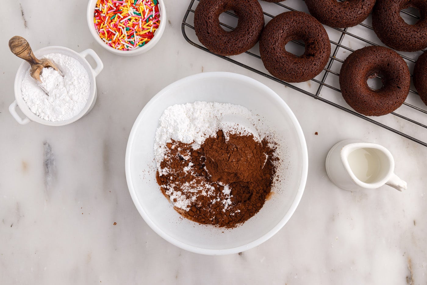 cocoa powder and powdered sugar in a bowl with milk