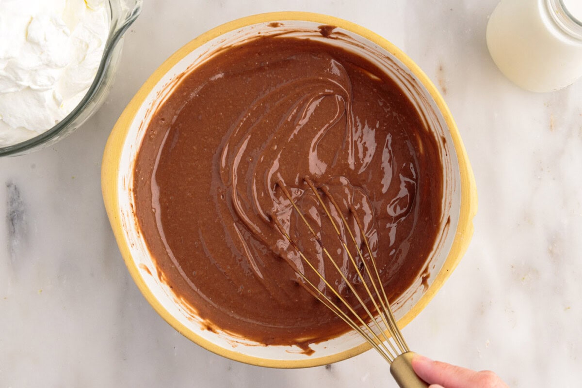 whisking instant pudding with milk in a bowl