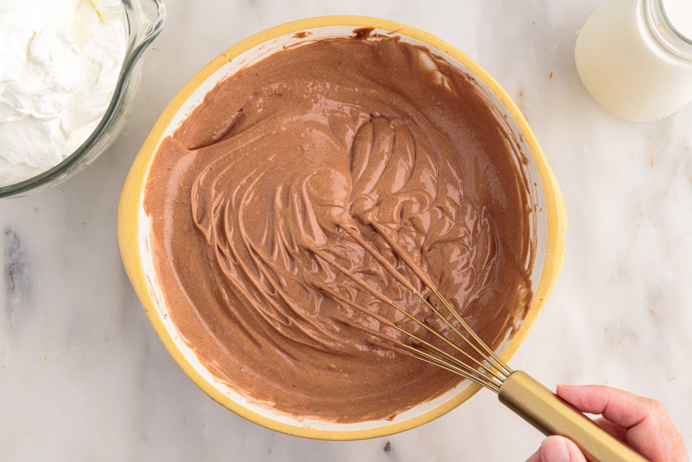 whisking whipped chocolate pudding in a bowl