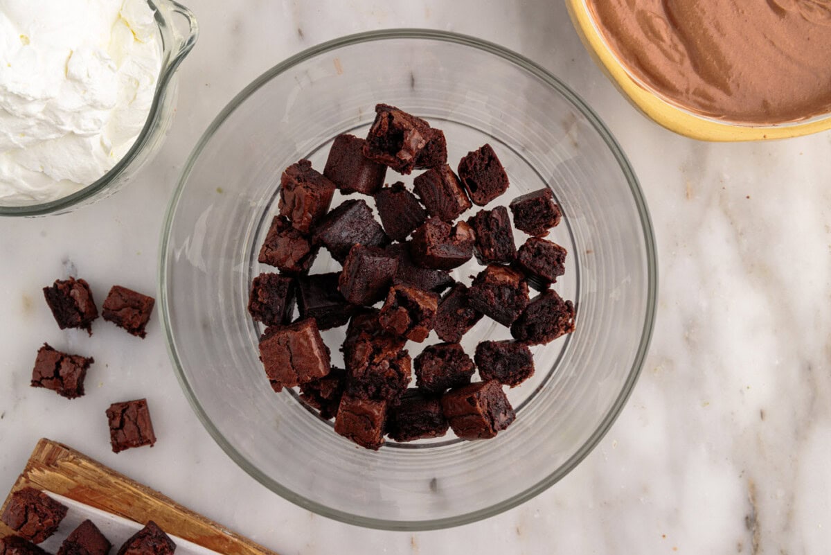 layer of brownie chunks in a trifle bowl