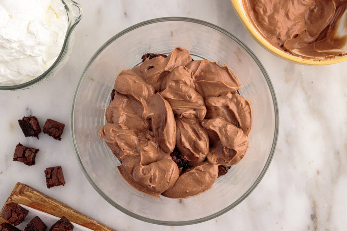 whipped chocolate pudding over brownie chunks in a trifle dish