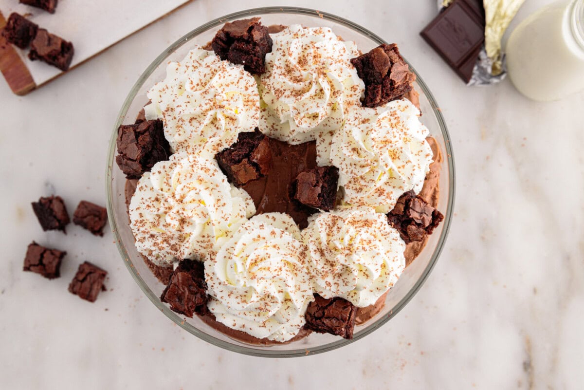 brownie pieces added to garnish of whipped cream and chocolate shavings over brownie trifle