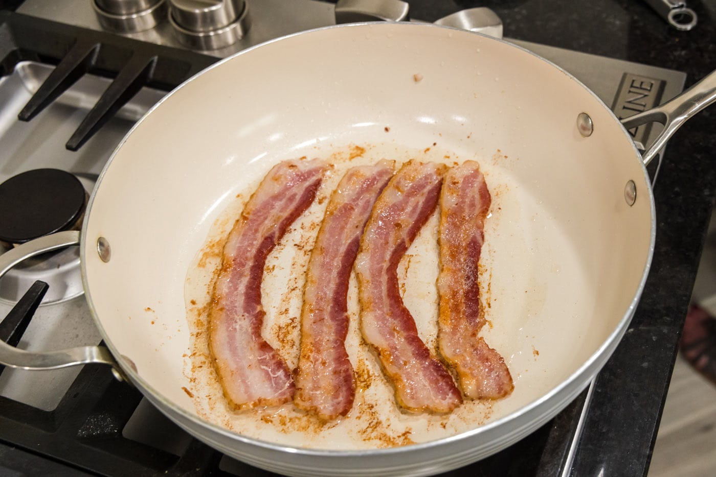 cooked bacon strips in a skillet
