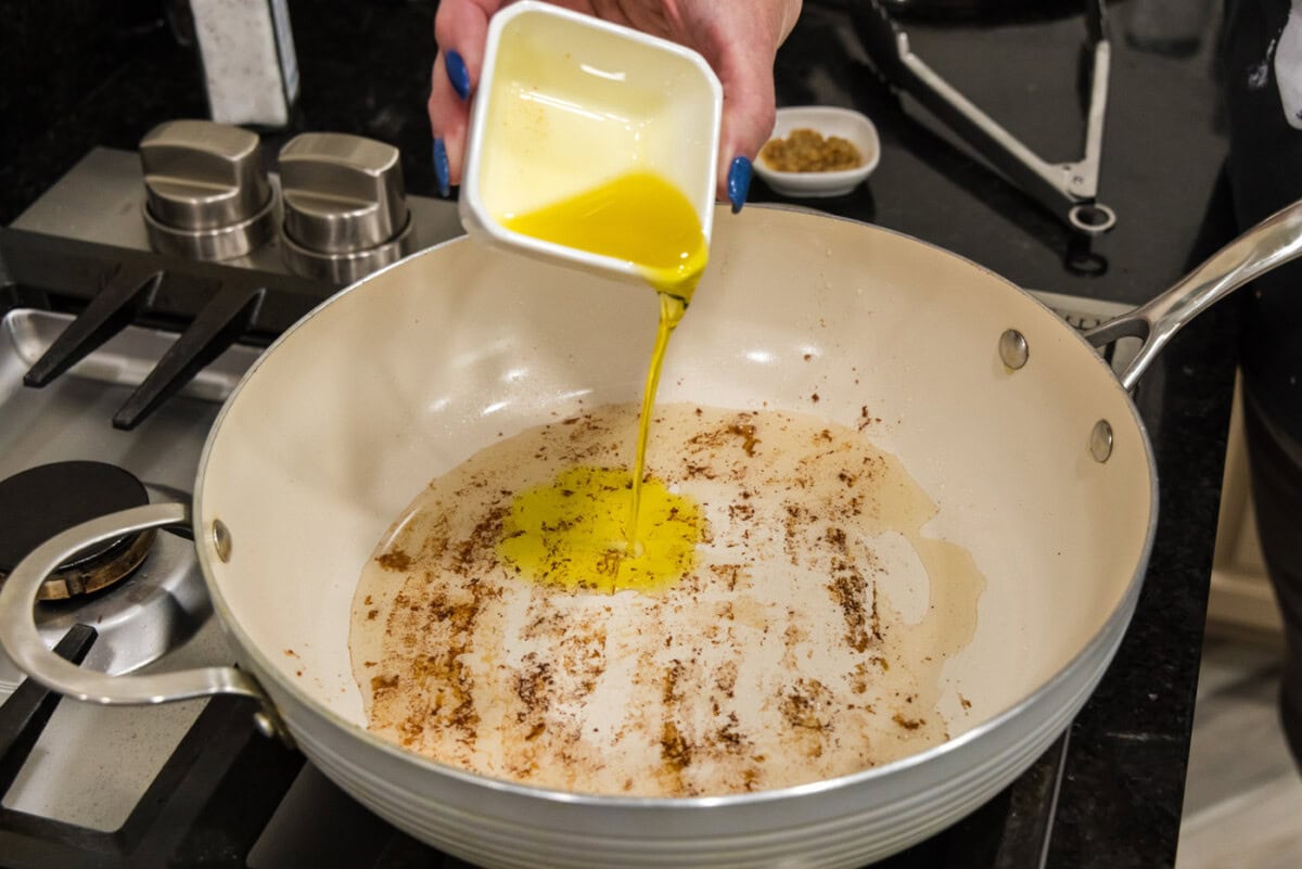 pouring oil into a skillet
