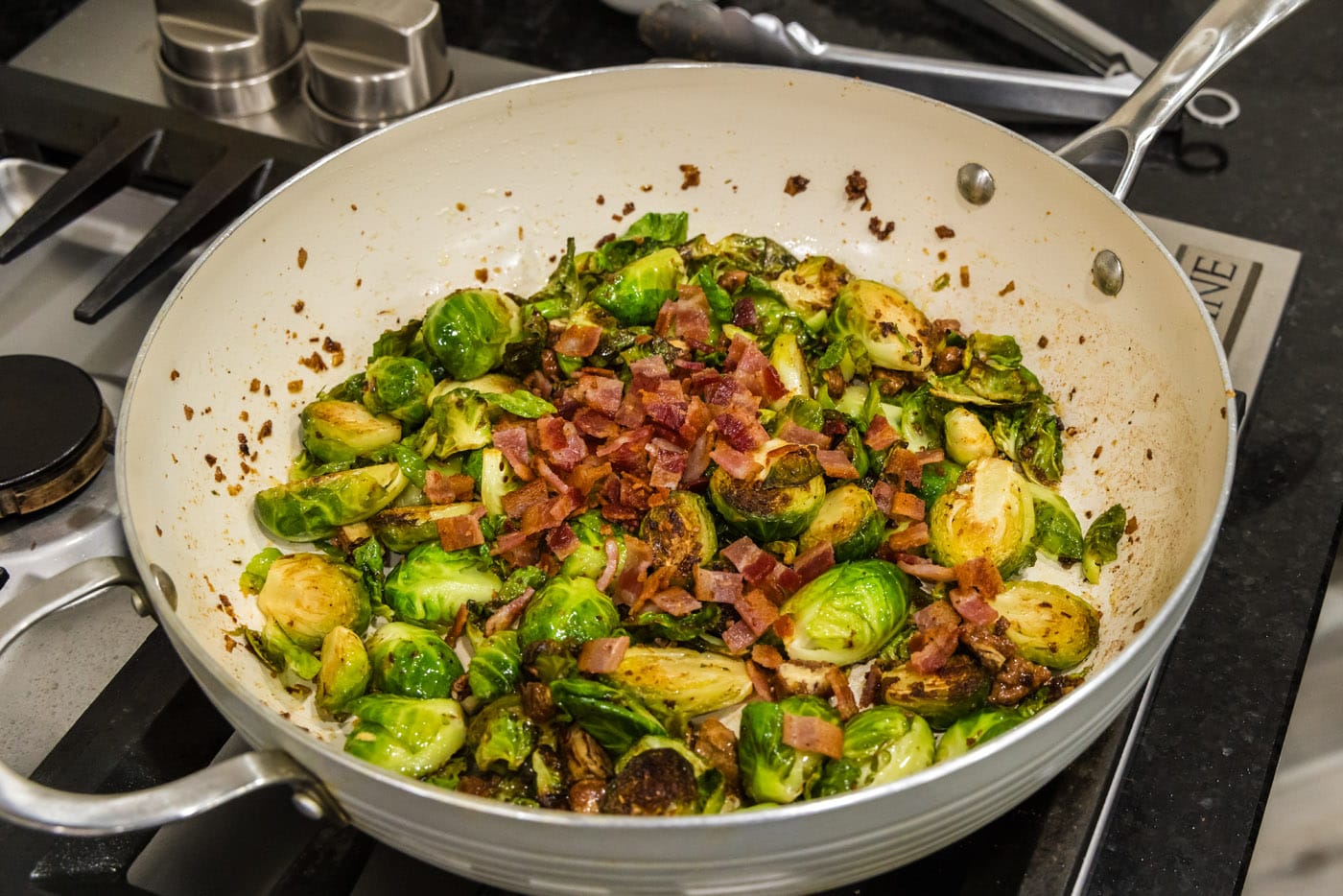 chopped bacon added to brussels sprouts with candied pecans