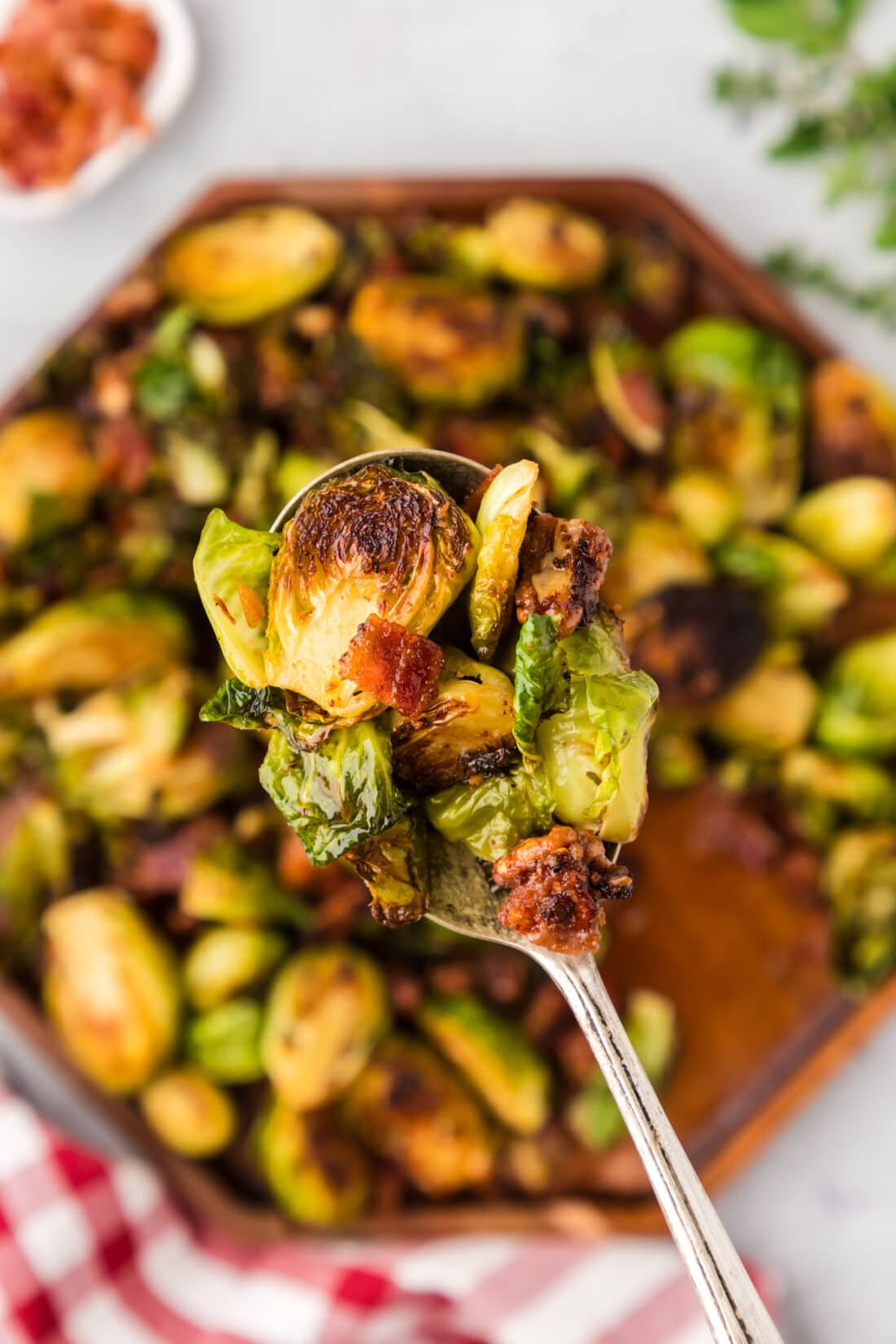 Close up photo of a spoonful of Brussels Sprouts with Bacon, Shallots and Candied Pecans