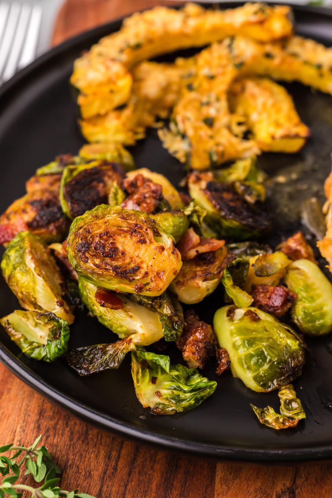 Brussels Sprouts with Bacon, Shallots and Candied Pecans on a plate with Air Fryer Acorn Squash
