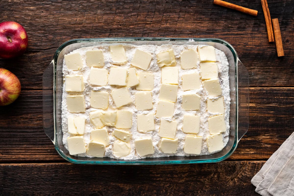 pats of butter on top of caramel apple dump cake