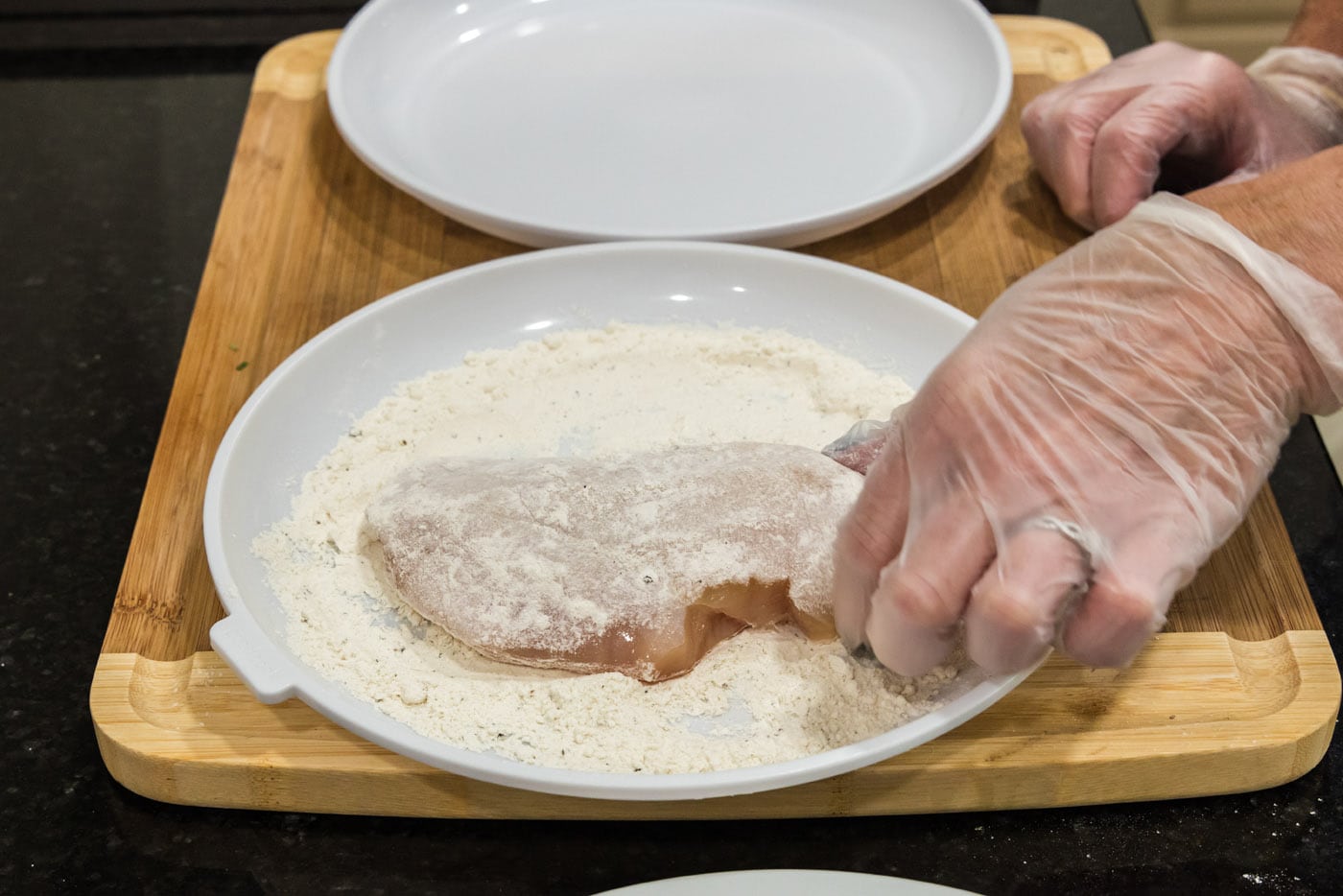 dredging chicken breast in flour