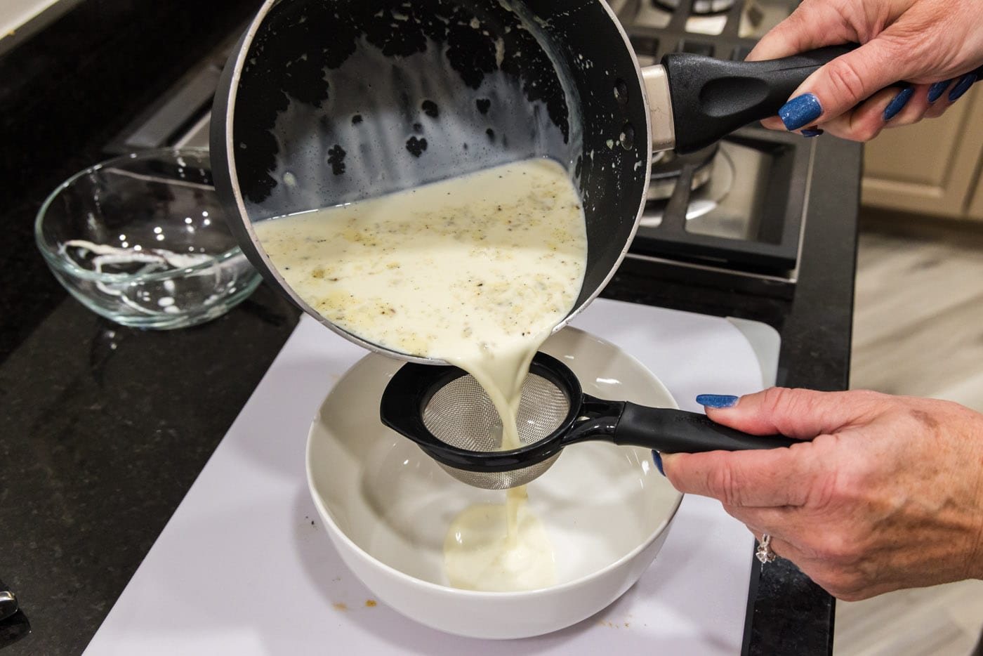 pouring custard filling through a sieve