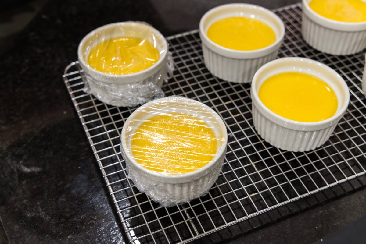 plastic wrap covering custard in a ramekins