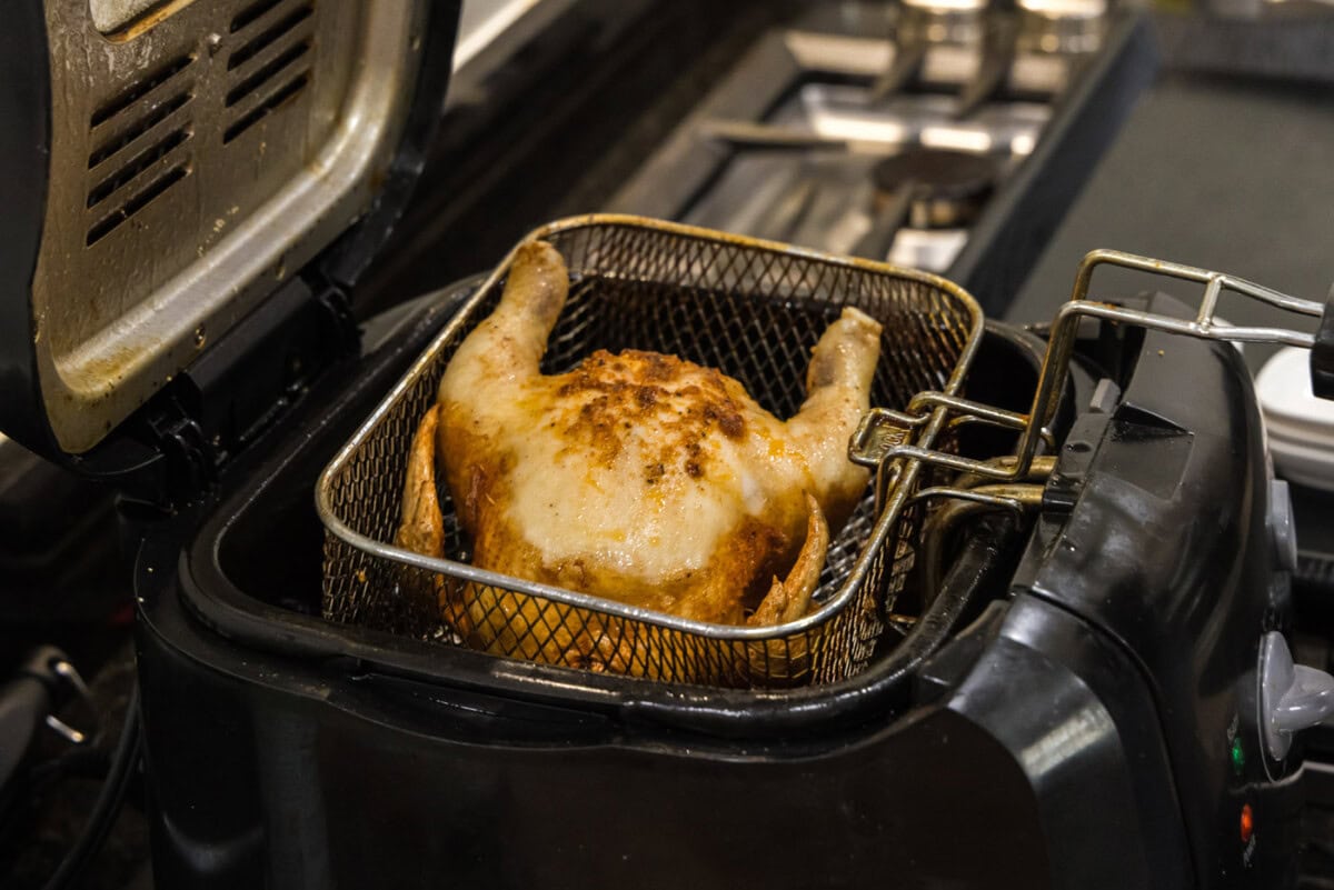 lifting cornish hen from deep fryer basket