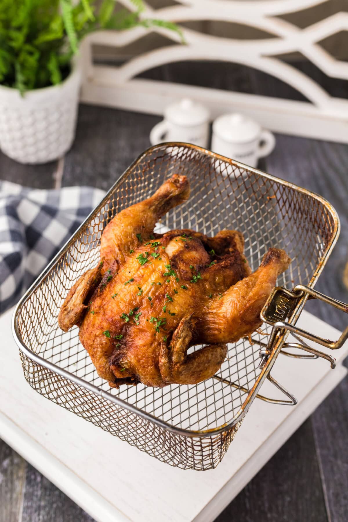 Deep Fried Cornish Hen in a deep fryer basket