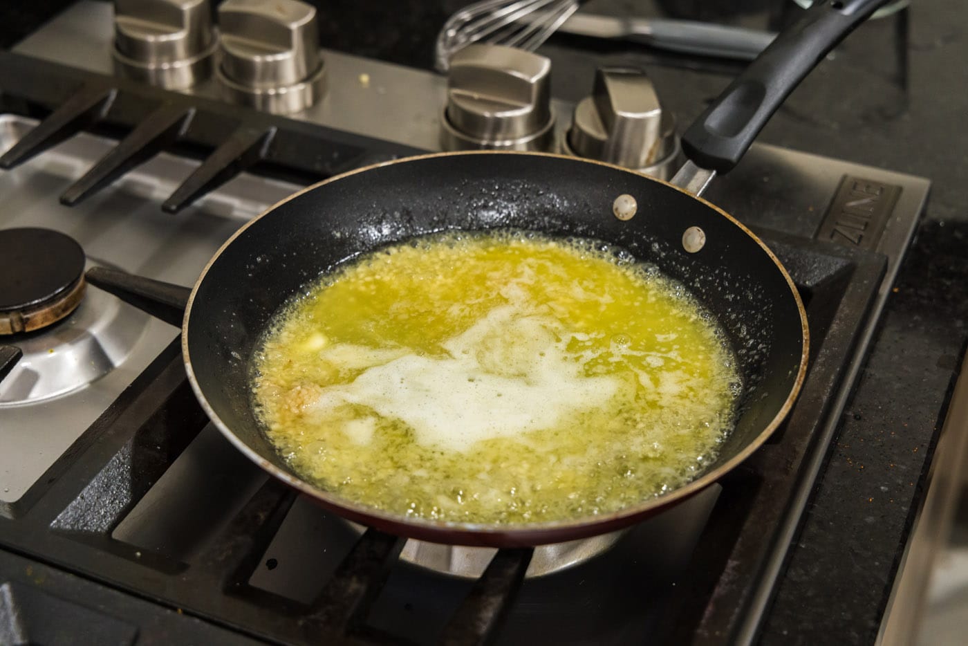 cooking garlic butter sauce in a skillet