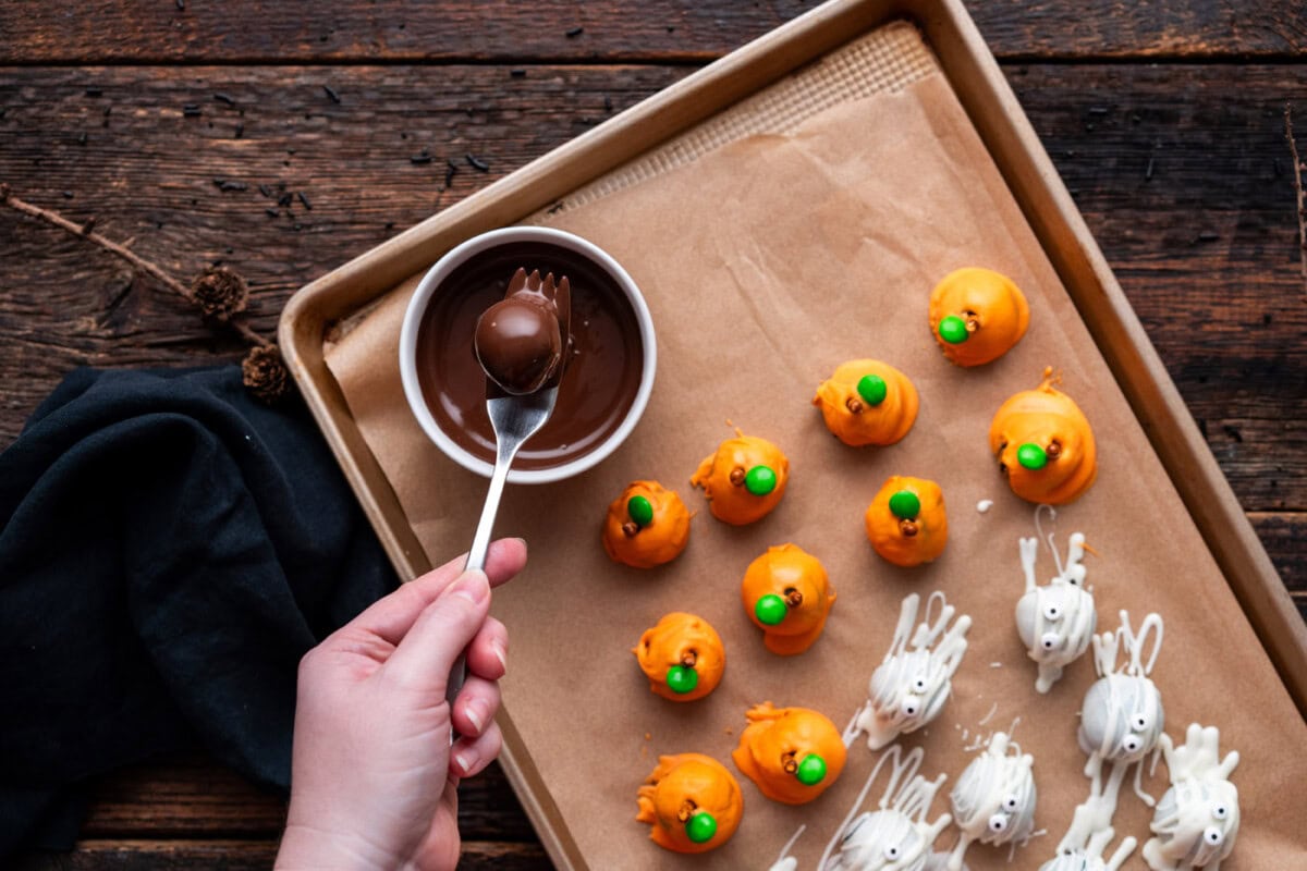 dipping oreo truffle into chocolate