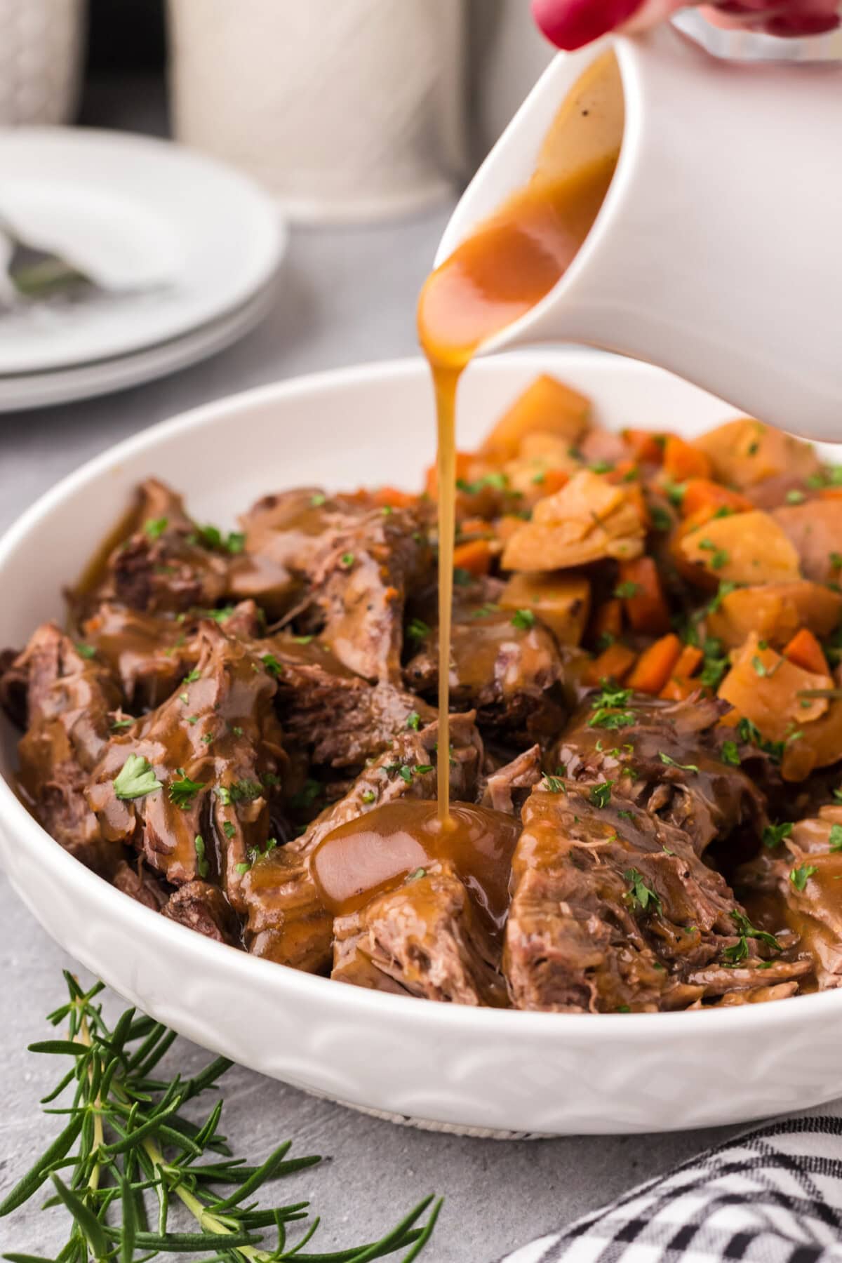 Gravy being poured over Instant Pot Roast Beef 