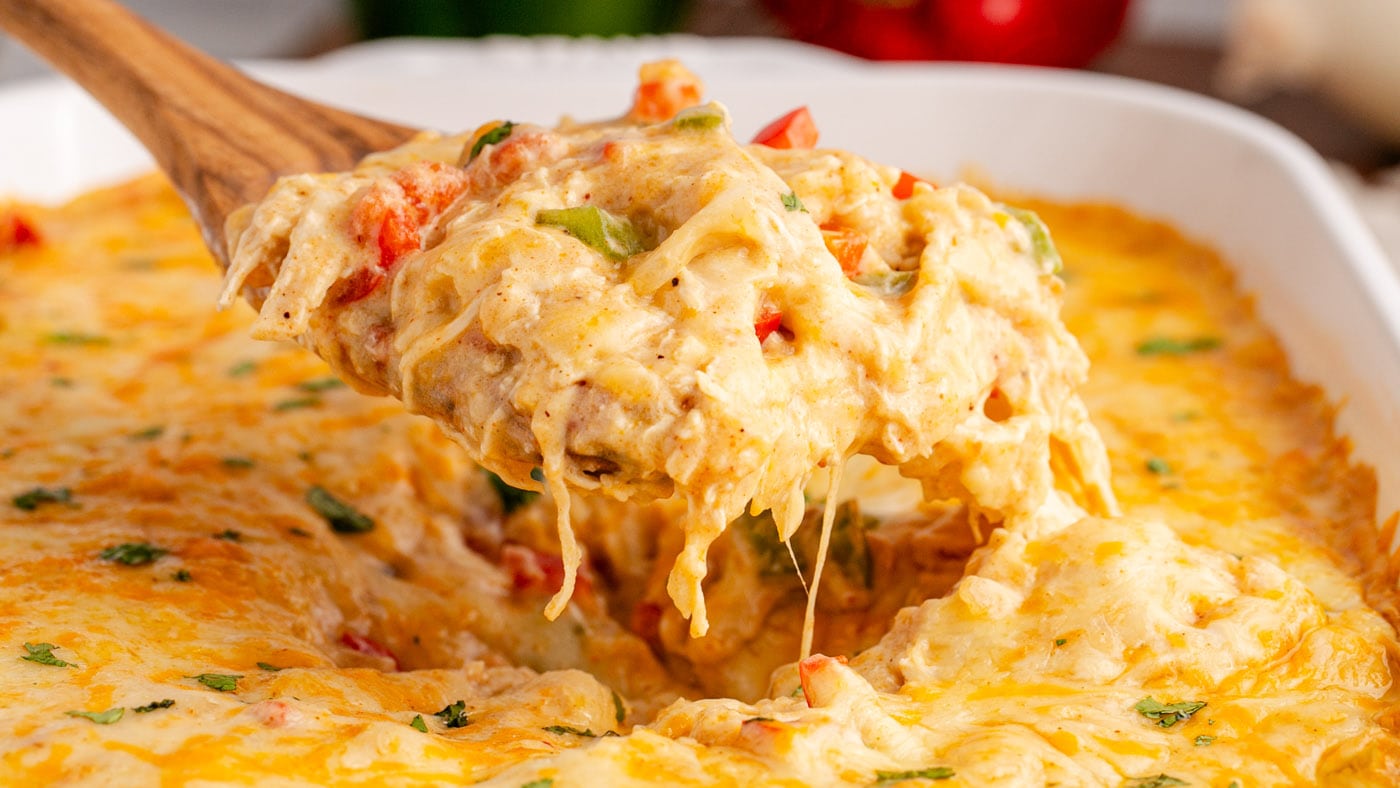 Each forkful of king ranch casserole is loaded with pulled chicken and soft tortillas smothered in a