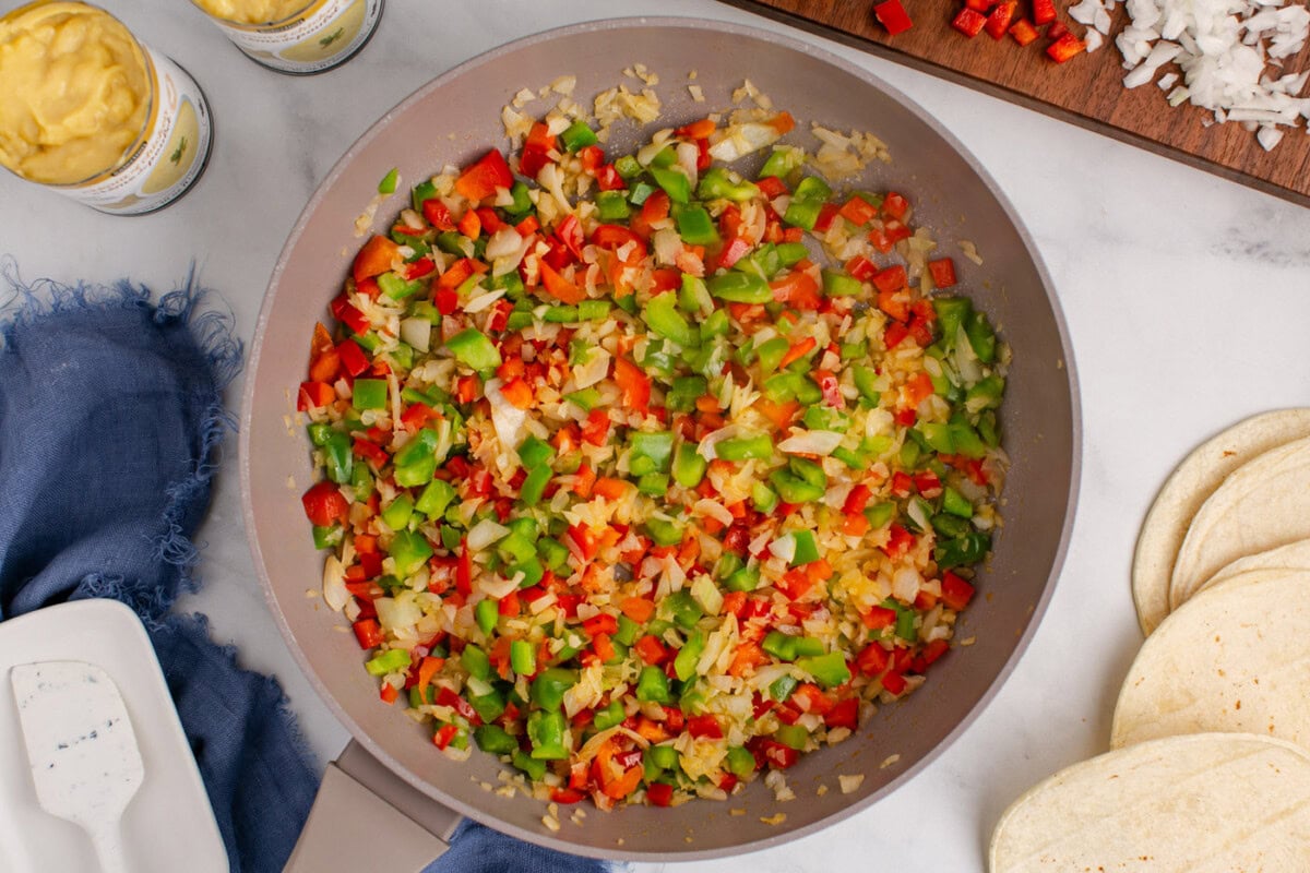 sauteed bell peppers and onion in a skillet