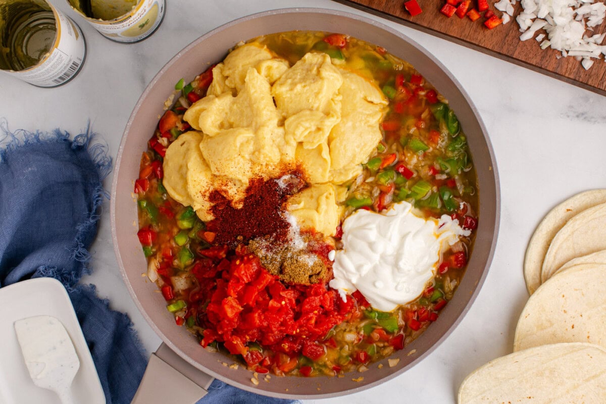 cream of chicken, seasonings, and sour cream added to sauteed veggies in a skillet