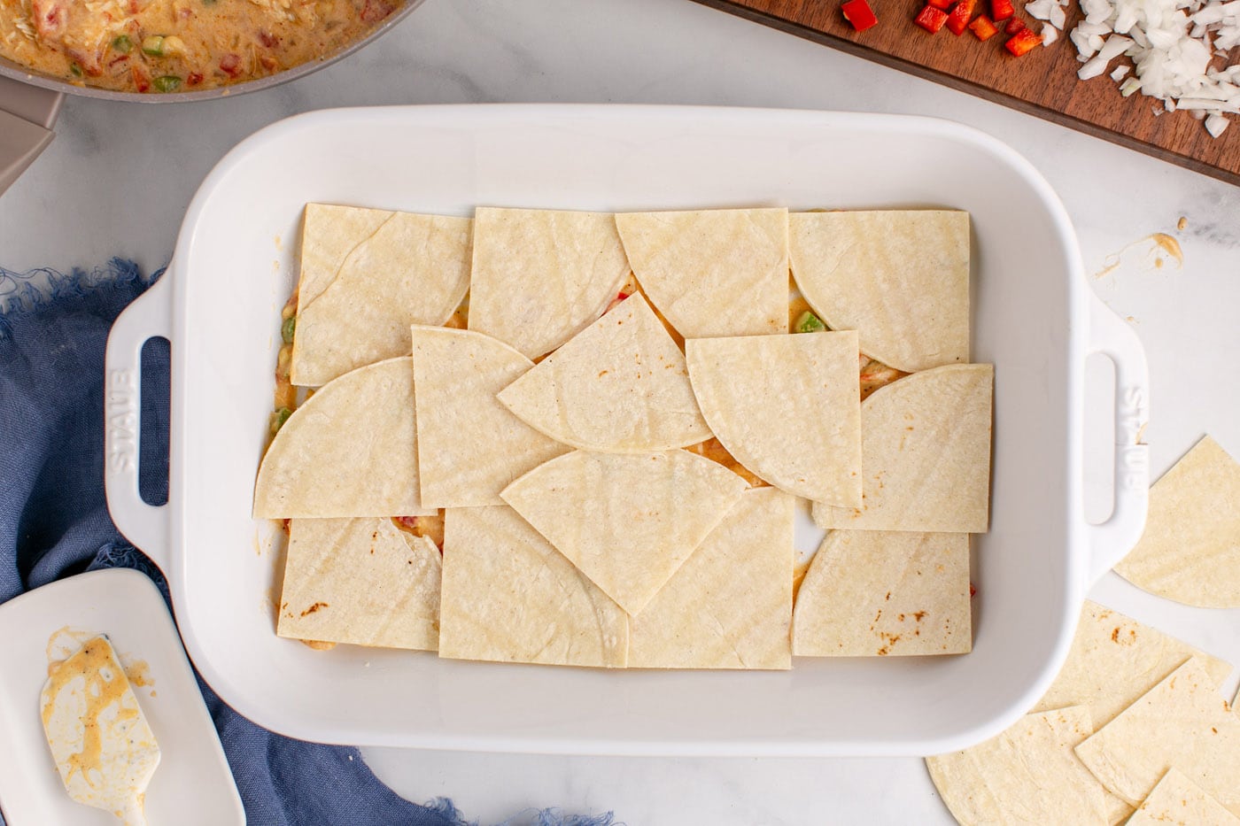 tortilla triangles layered in a baking dish