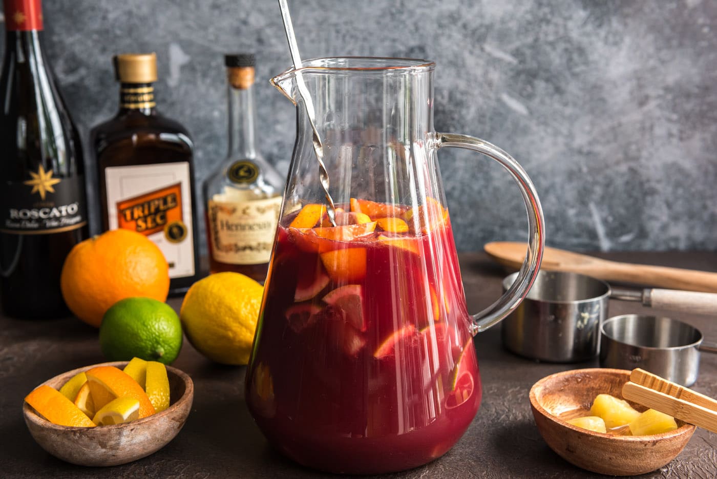 stirring mexican sangria in a pitcher