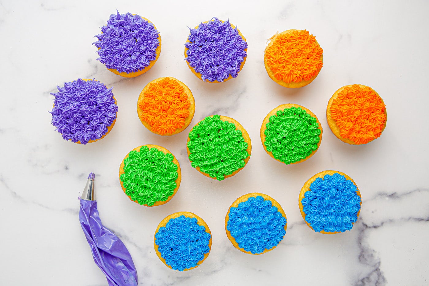 colorful piped frosting on top of cupcakes
