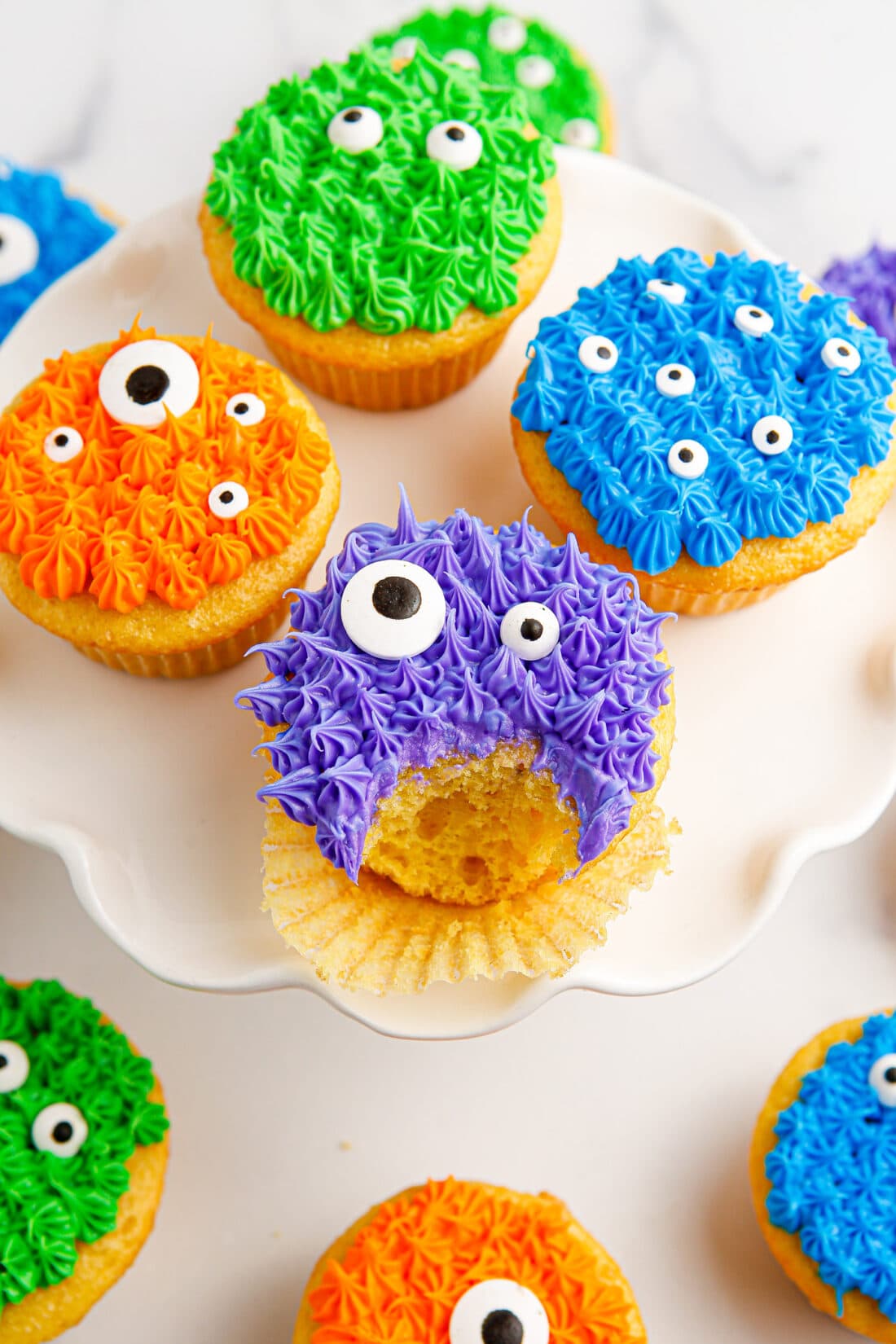 Monster Cupcakes on a cake stand with a bite taken out of one