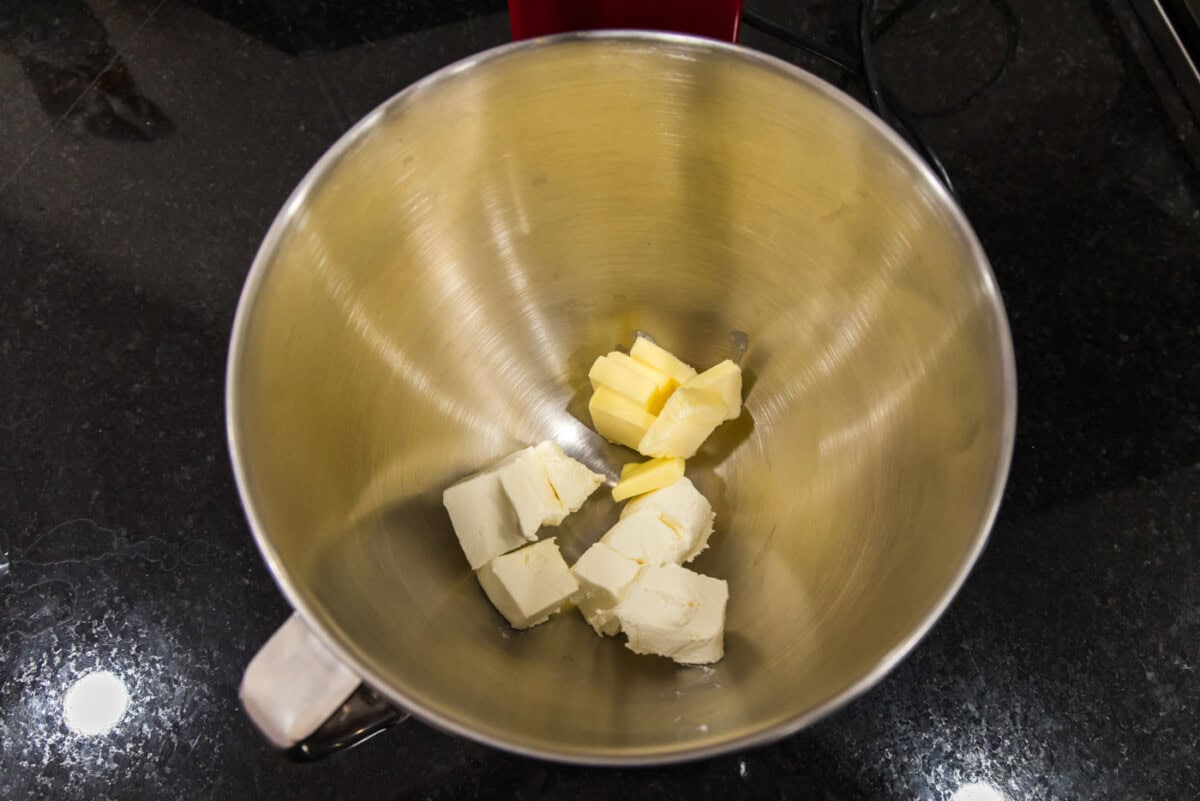 butter and cream cheese in a bowl of a stand mixer