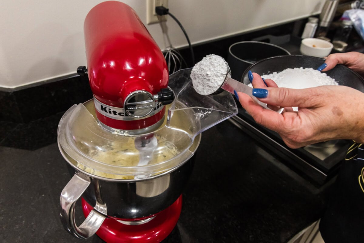 adding powdered sugar to butter and cream cheese mixture