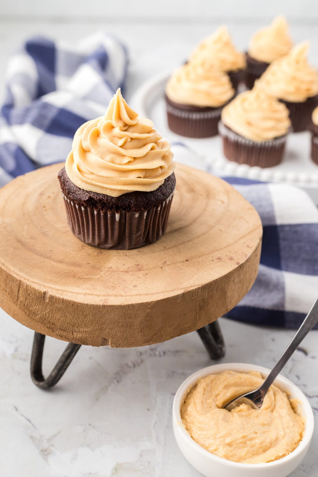 Cupcakes topped with Peanut Butter Frosting and a bowl of frosting on the side