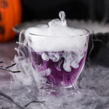 Close up photo of a smoky Purple People Eater Cocktail