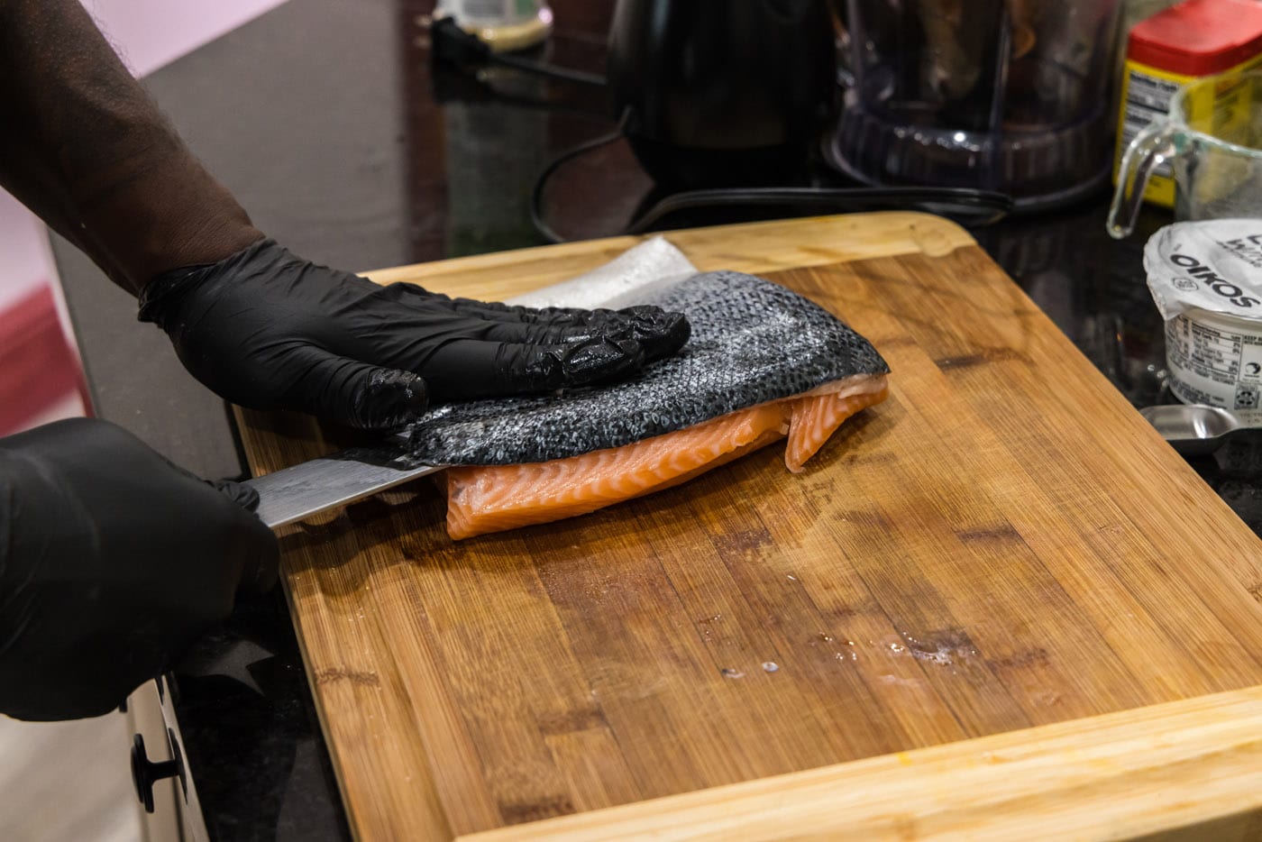 removing skin from salmon with a chef knife