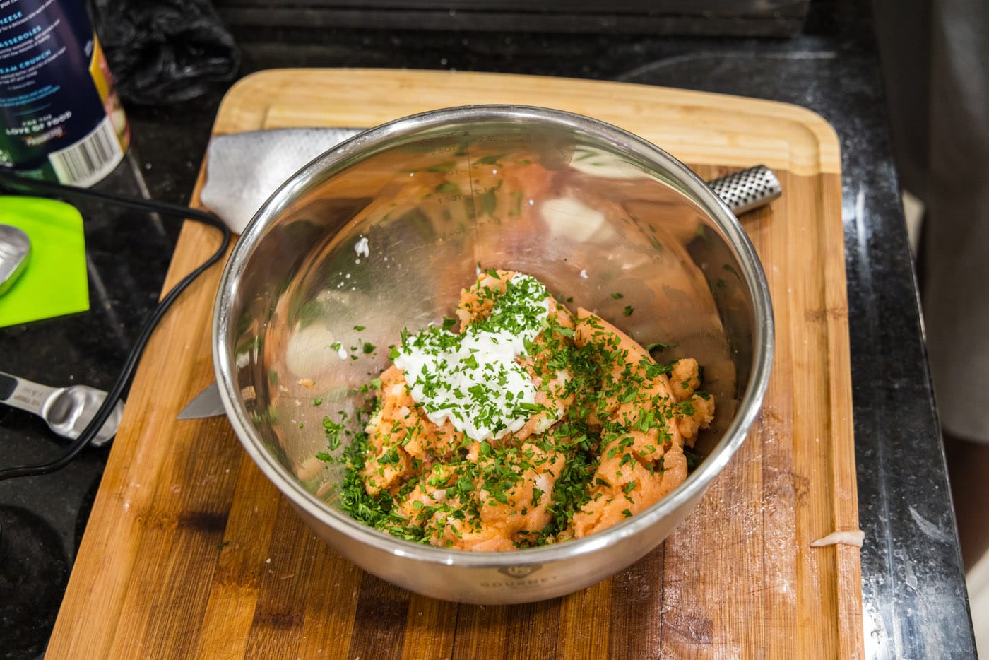 Adding yogurt and herbs to blended salmon mixture