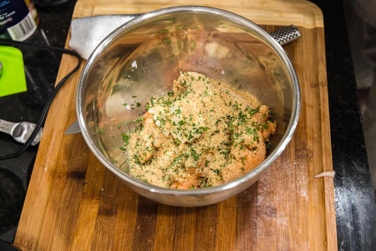 adding seasonings and herbs to salmon mixture